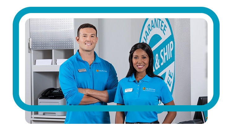 A male and female coworker in UPS store uniforms looking professional.